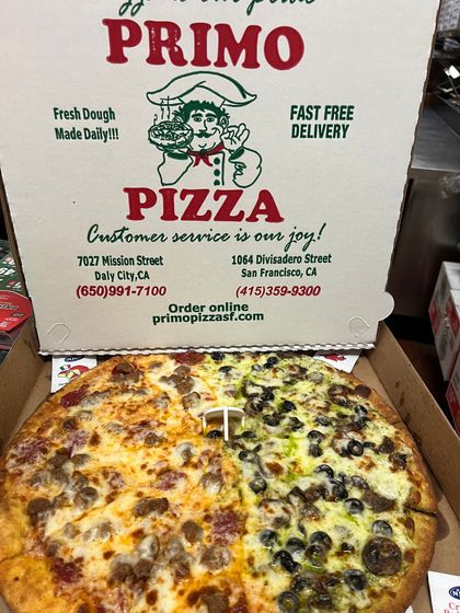 A pizza in a cardboard box from primo pizza