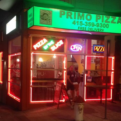A primo pizza restaurant is lit up at night
