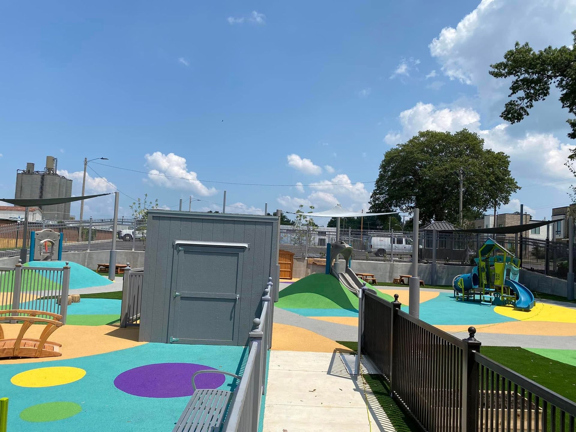 Colorful playground with various structures and blue sky.
