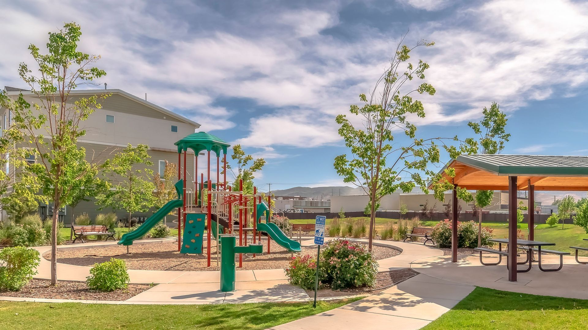 Community playground and picnic shelter in a landscaped neighborhood park
