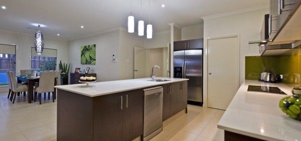 A kitchen with a large island and stainless steel appliances