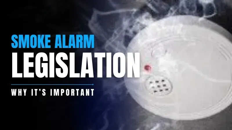 A smoke detector is surrounded by smoke on a black background.