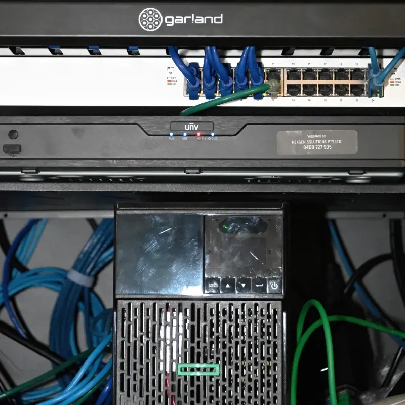 A server rack with a fan on top of it