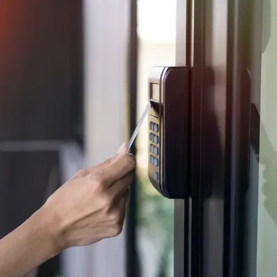A person is using a key card to open a door.