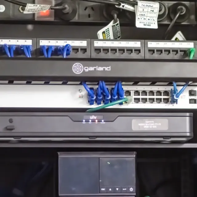 A server rack with a Garland router on top