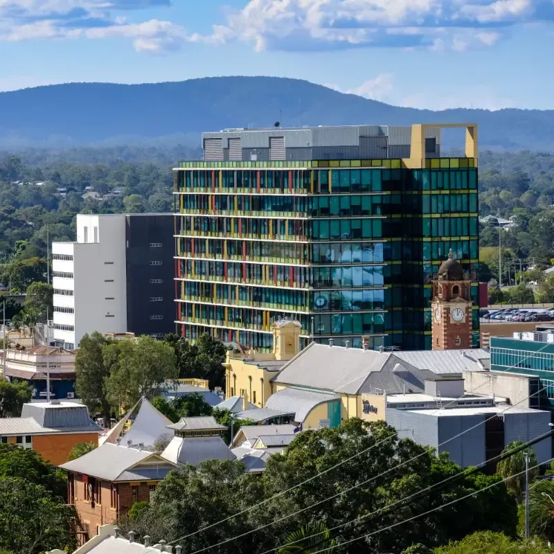 An aerial view of Ipswich city with mountains in the background