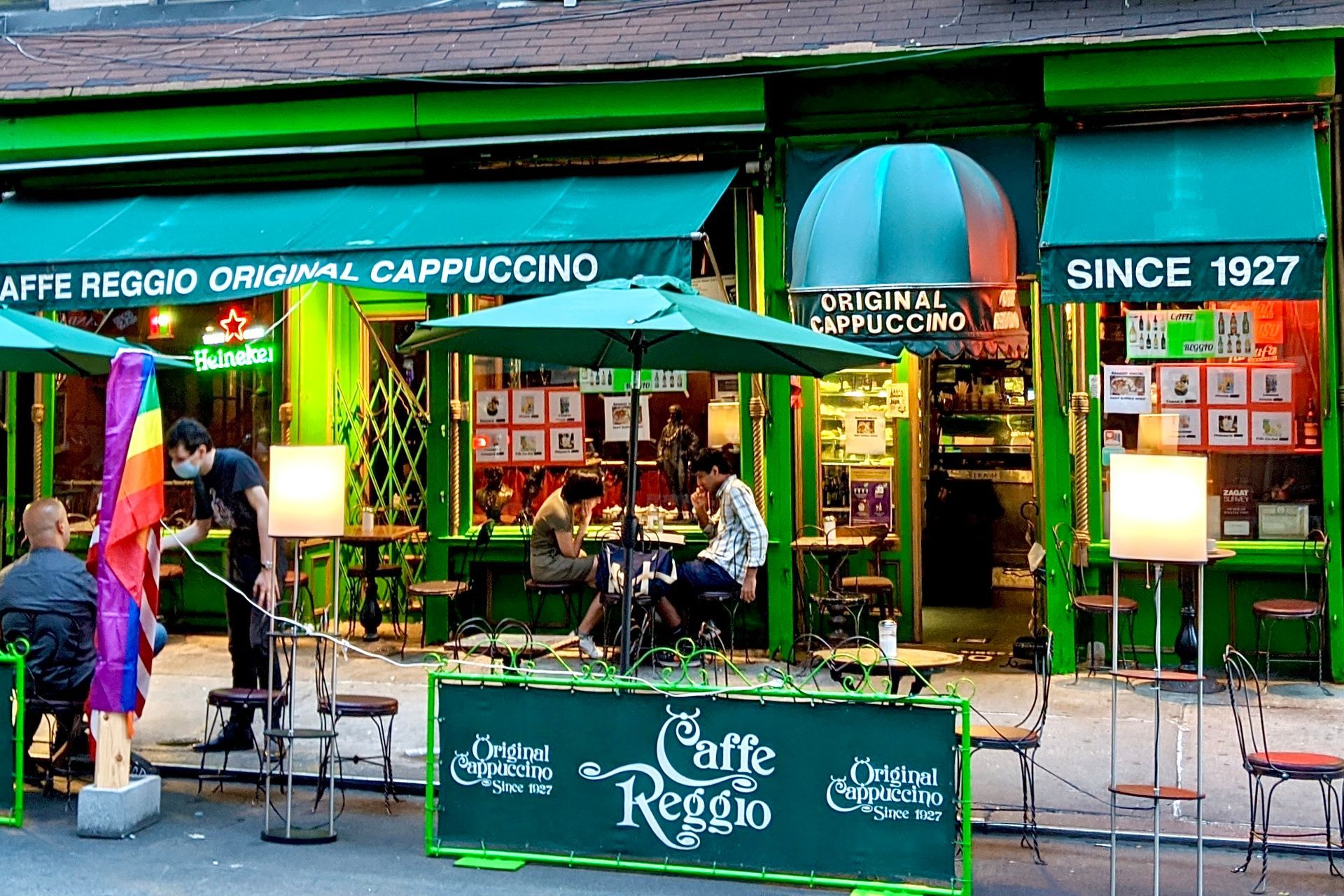 Exterior of Caffè Reggio, a historic Greenwich Village café serving cappuccinos since 1927.