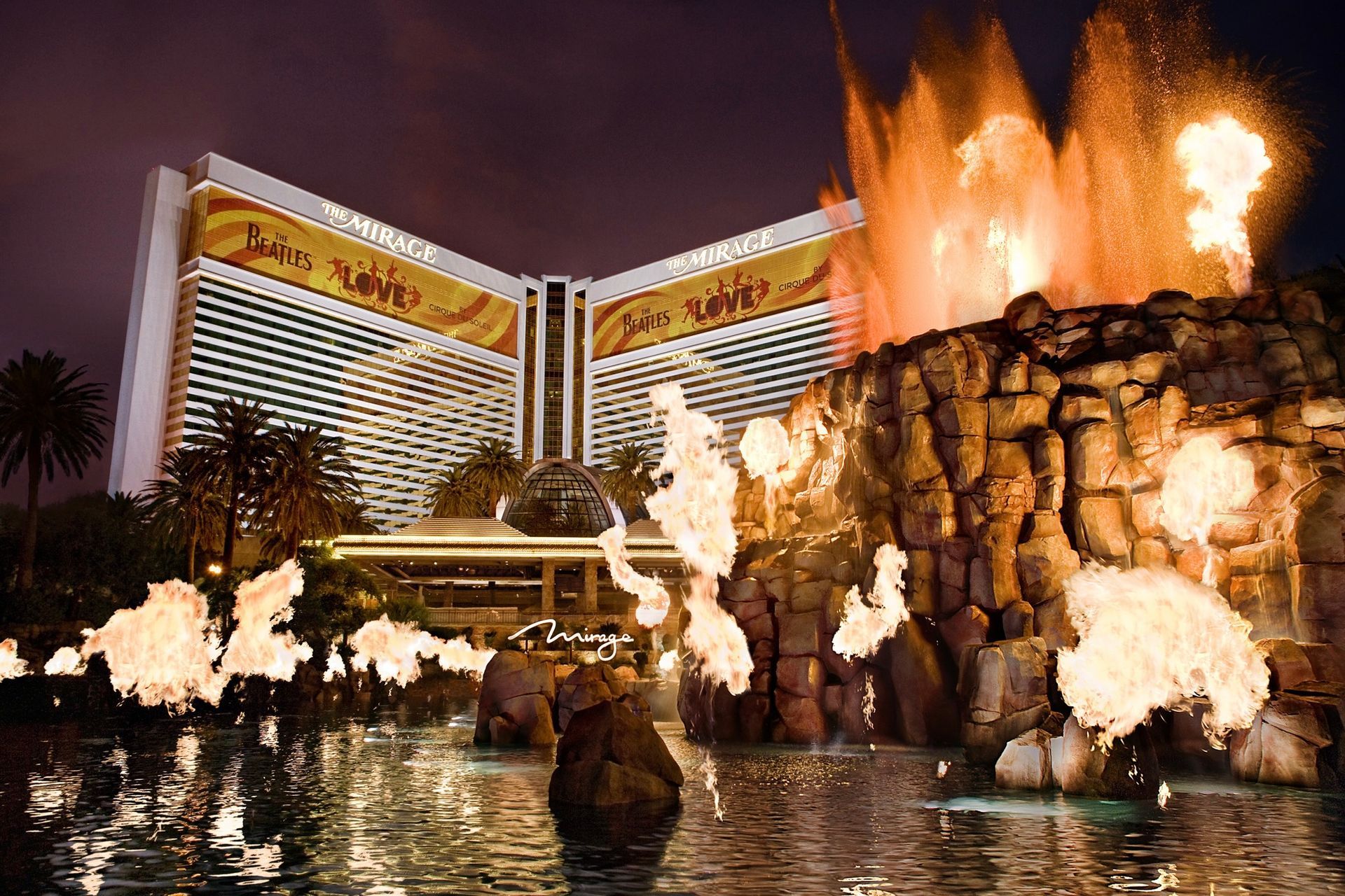 Artificial volcano erupting outside The Mirage hotel on the Las Vegas Strip at night.