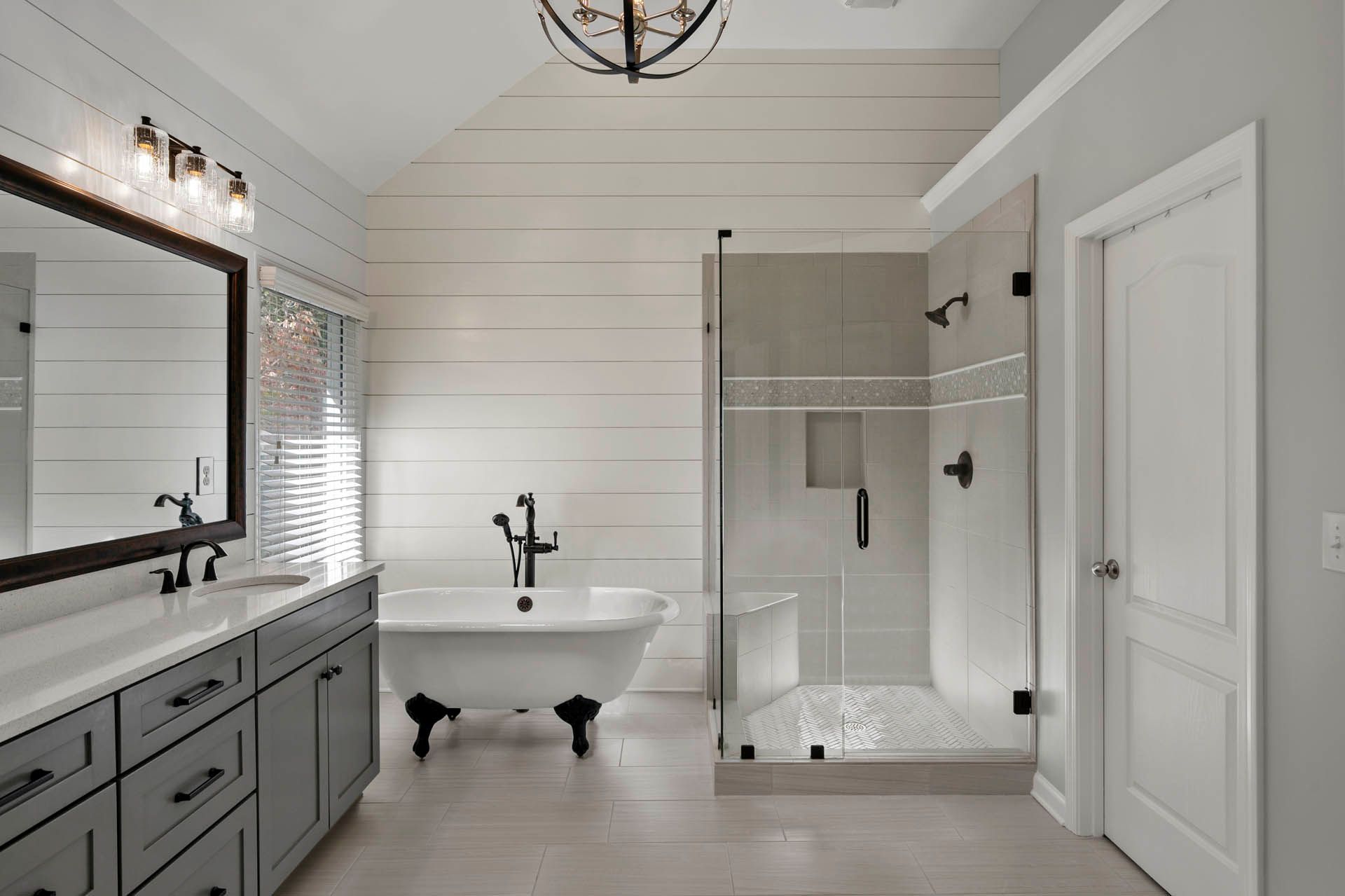 a bathroom with a claw foot tub and a walk in shower