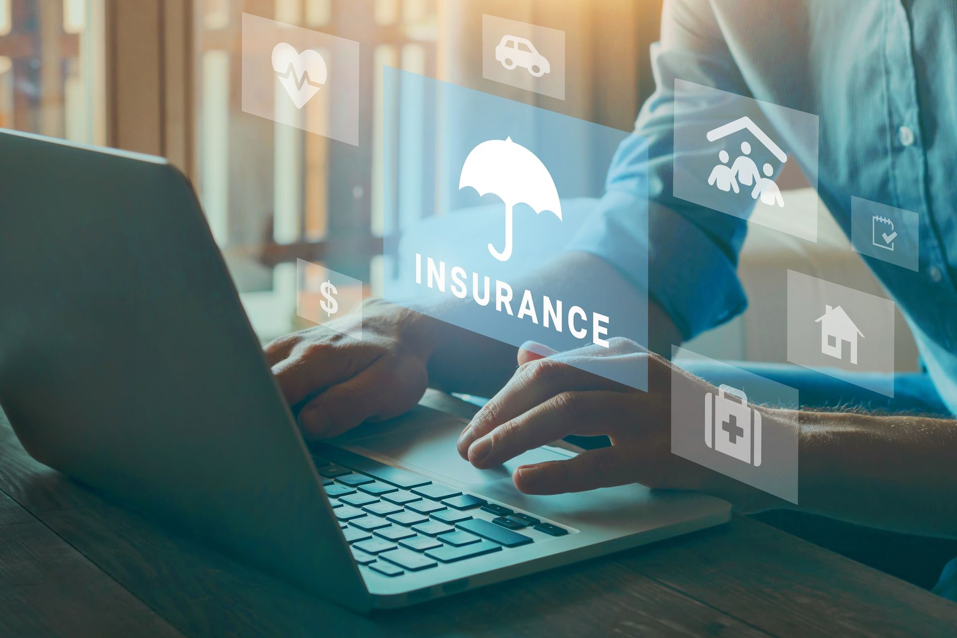 Person using a laptop with digital insurance icons overlaid.