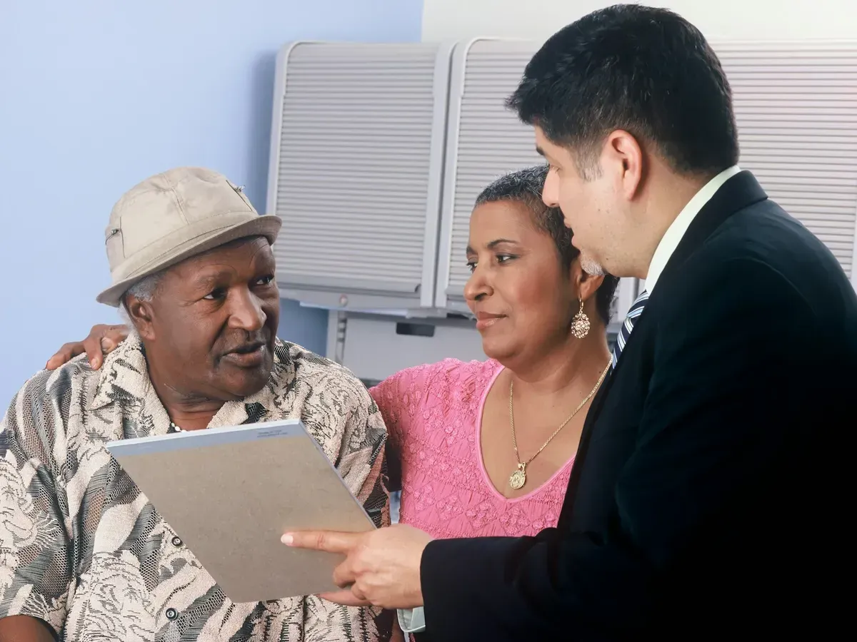 A financial advisor walking an older couple through a document