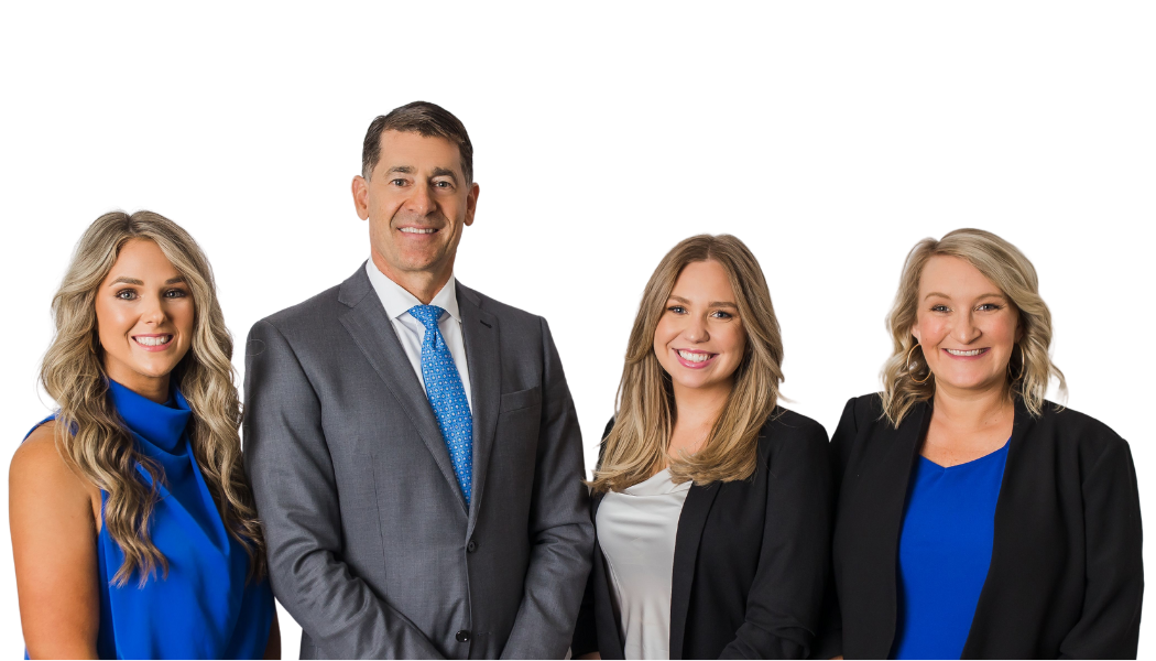 Four business professionals posing against a white background, wearing gray, black, and blue attire.