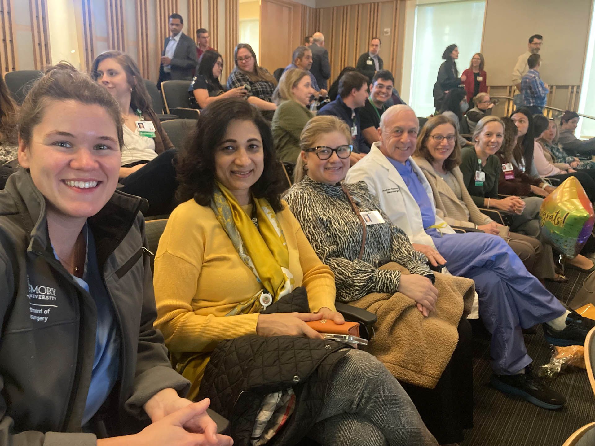 A group of people are sitting in chairs in a room.
