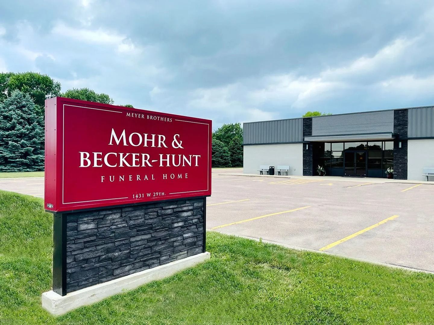 Mohr & Becker-Hunt Insurance sign outside office building under cloudy sky