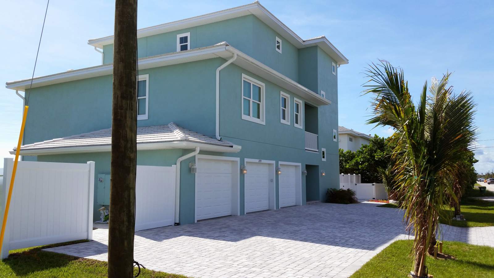 Outdoor Side View of a Home Painted with Blue — Vero Beach, FL — Bucio Painting Inc.