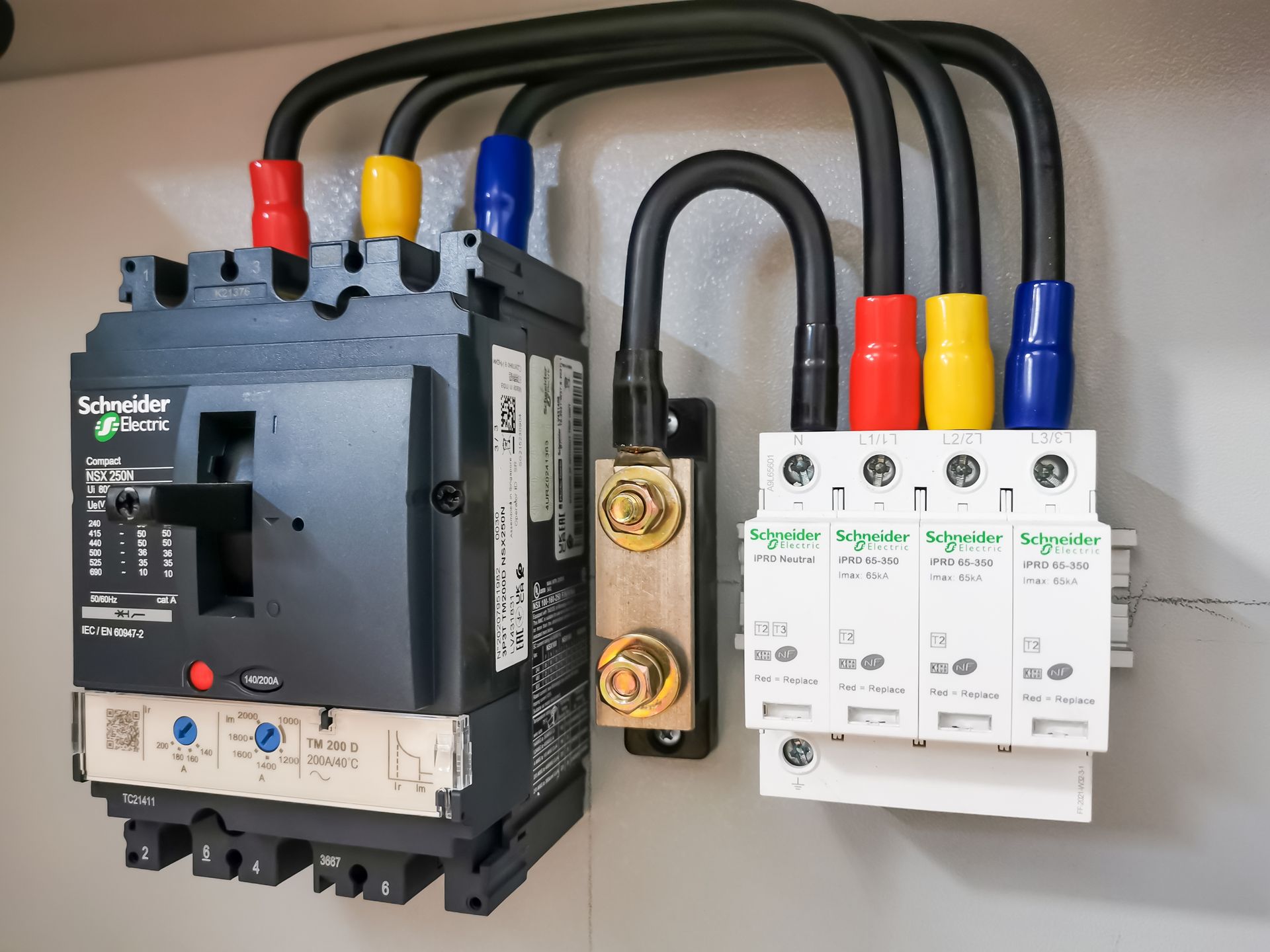A close up of a electrical panel with a breaker and a surge protector.