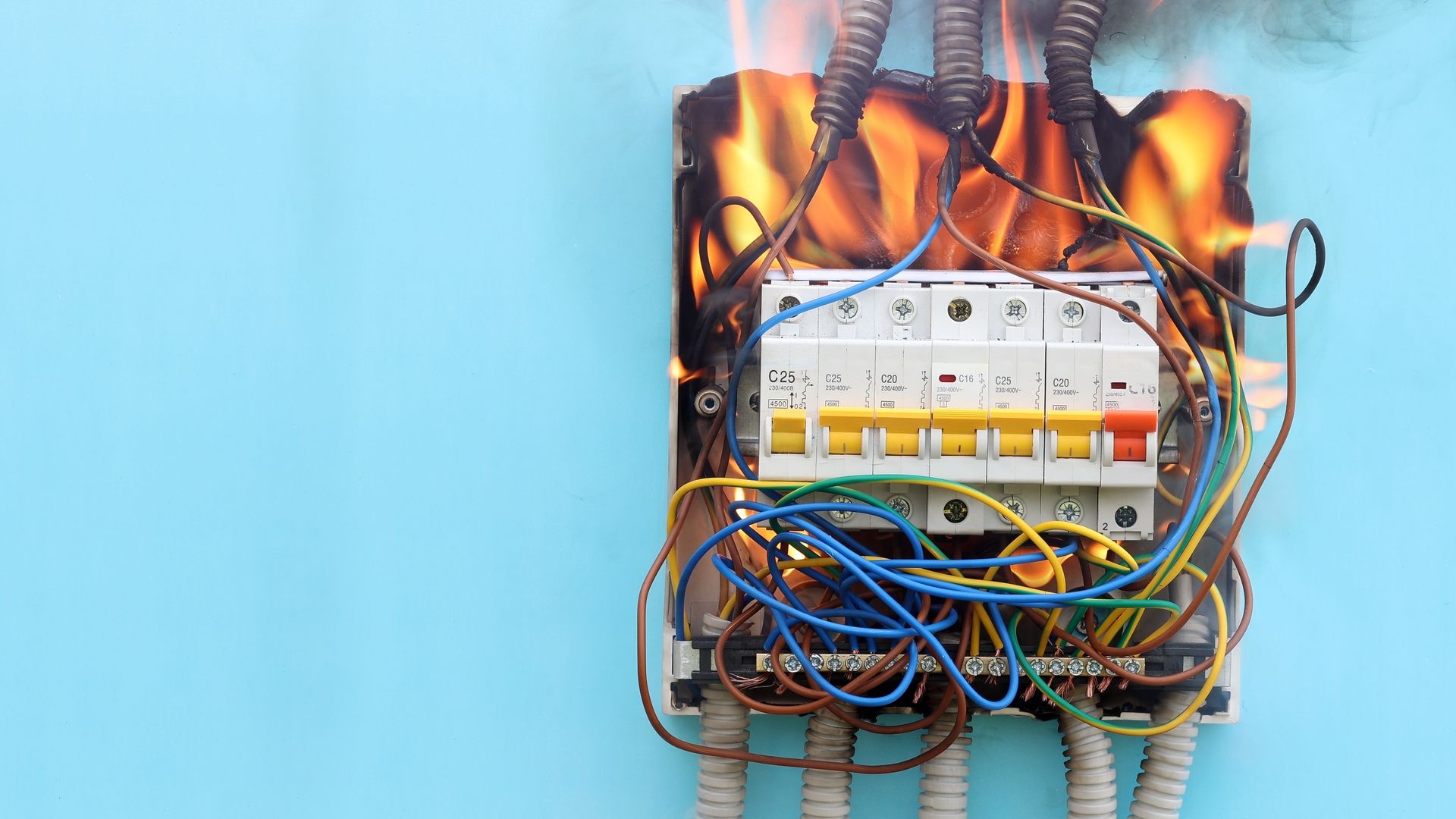 A fire is coming out of a electrical box.