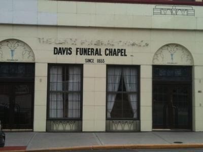Davis Funeral Chapel storefront with beige facade, black lettering, and dark windows.