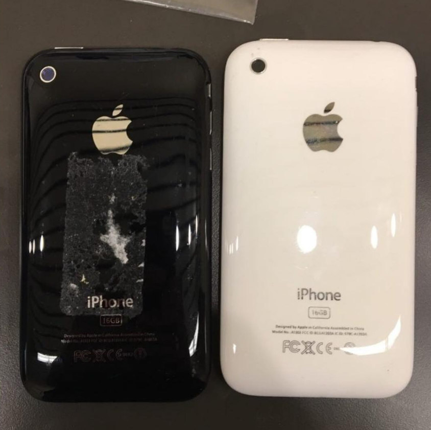 Two iPhones shown side by side, one black and one white, both viewed from the back.
