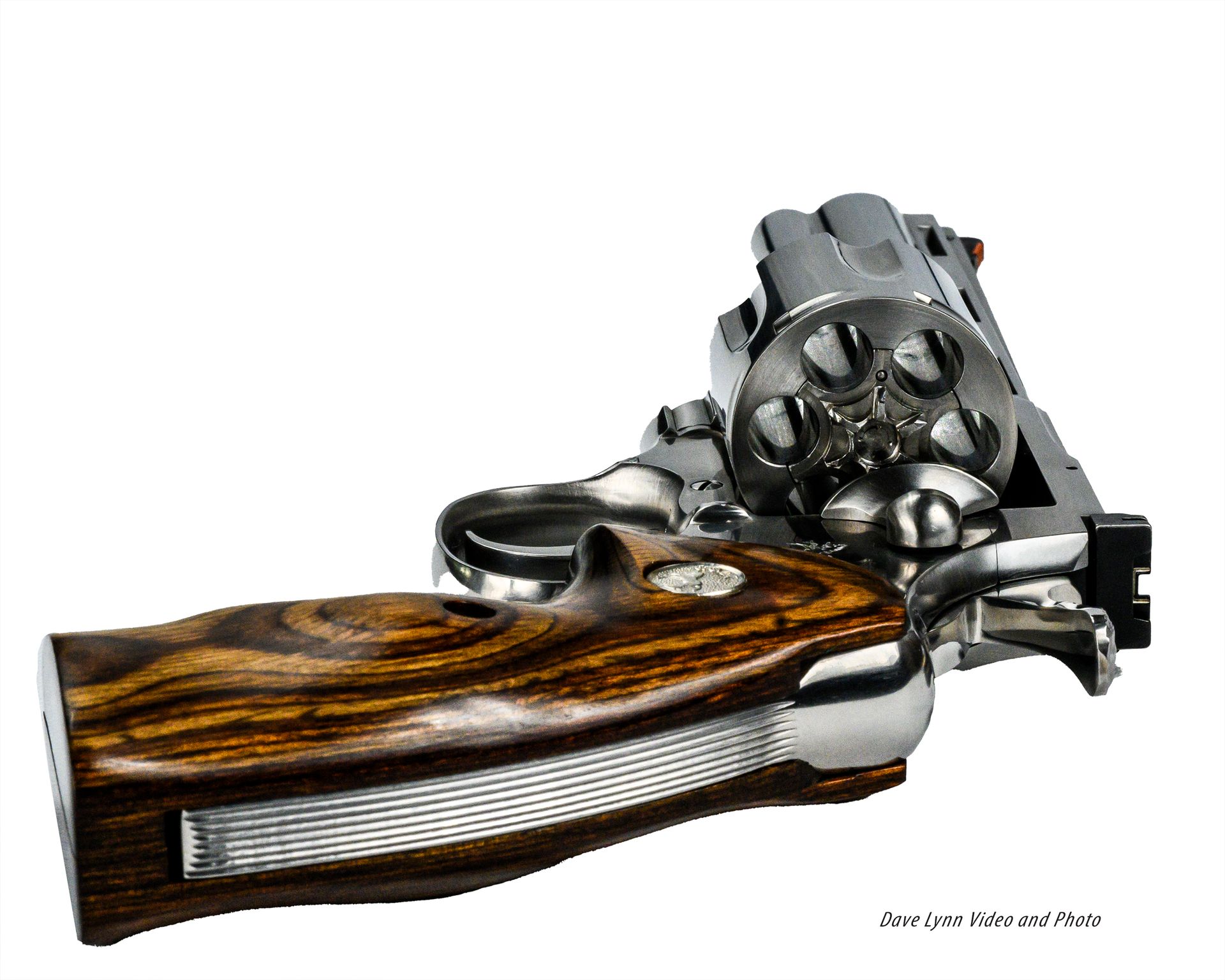 Wooden-handled revolver with cylinder and barrel shown on a white background