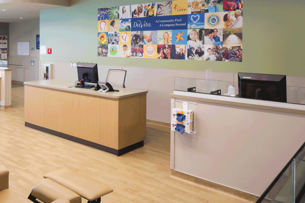 A hospital lobby with a collage of pictures on the wall