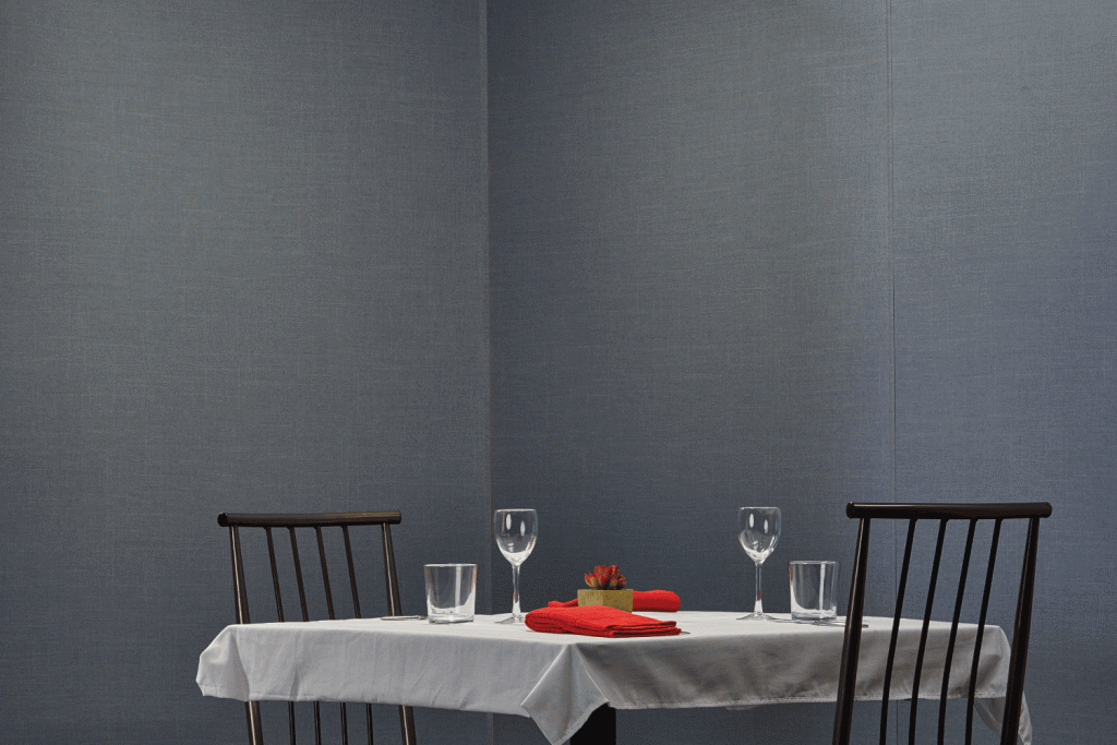 A table with two chairs and glasses on it