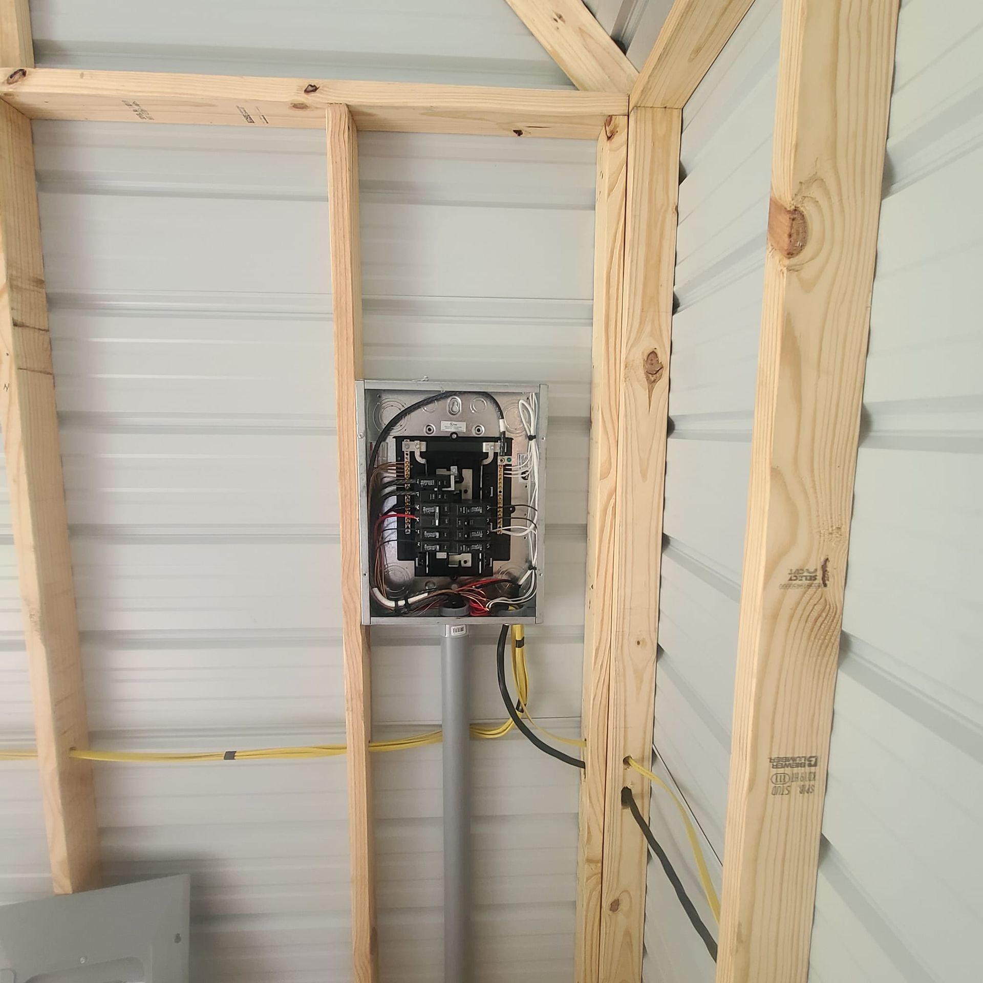An electrical box is hanging from the ceiling of a building