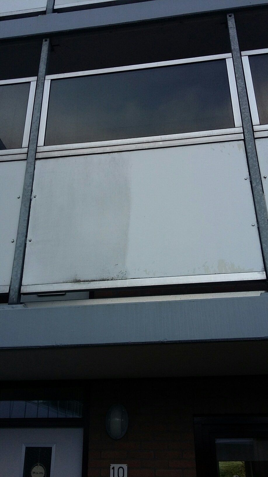 Een balkon aan de zijkant van een gebouw met het nummer 10 erop