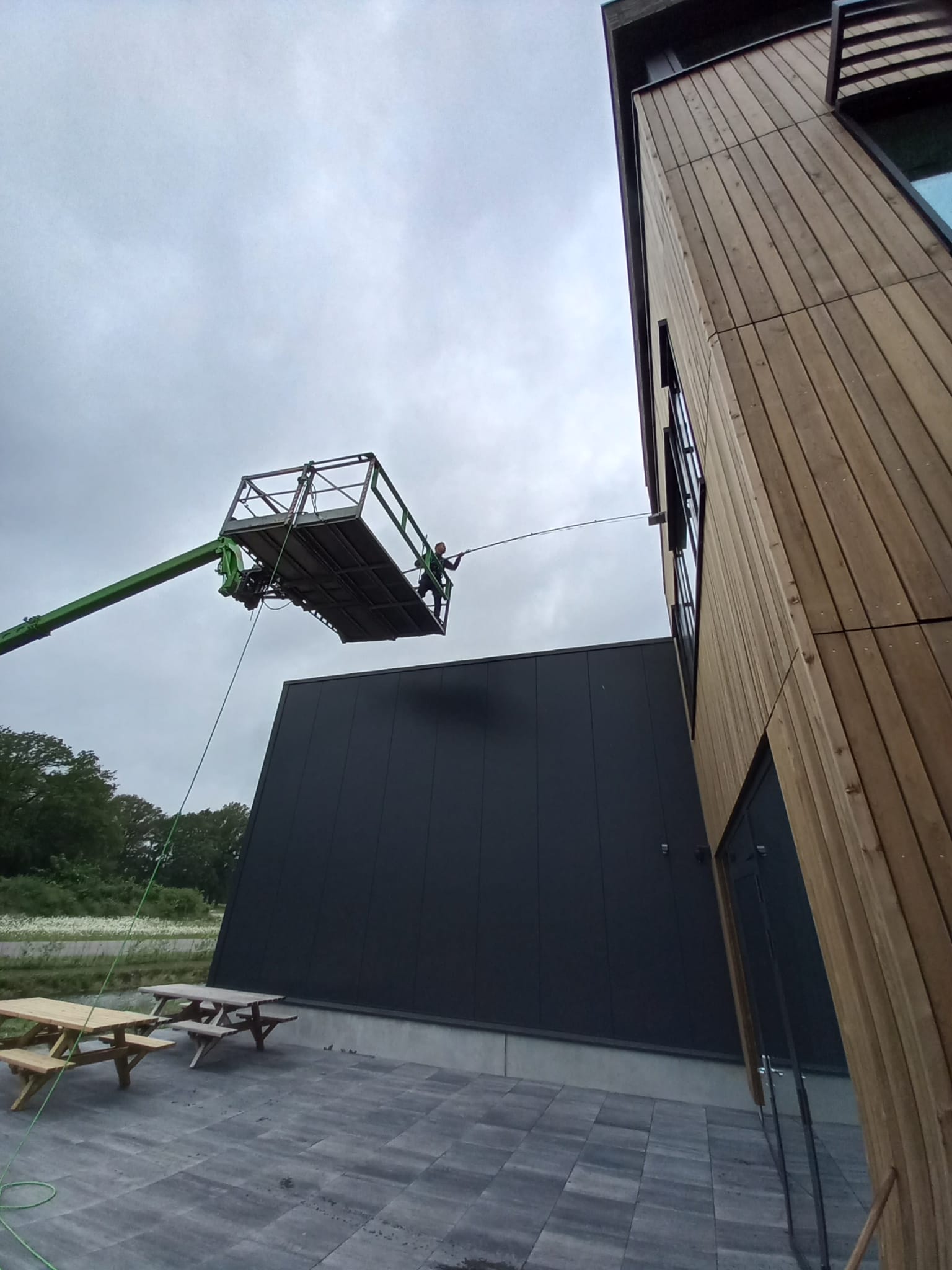 Een kraan wordt gebruikt om een ​​bord van een gebouw te verwijderen