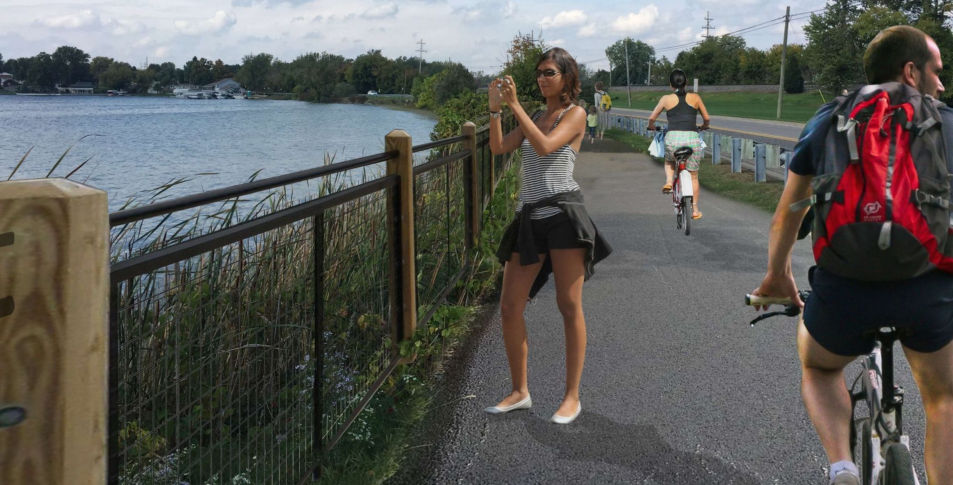 A woman is taking a picture on the concept trail overlooking water