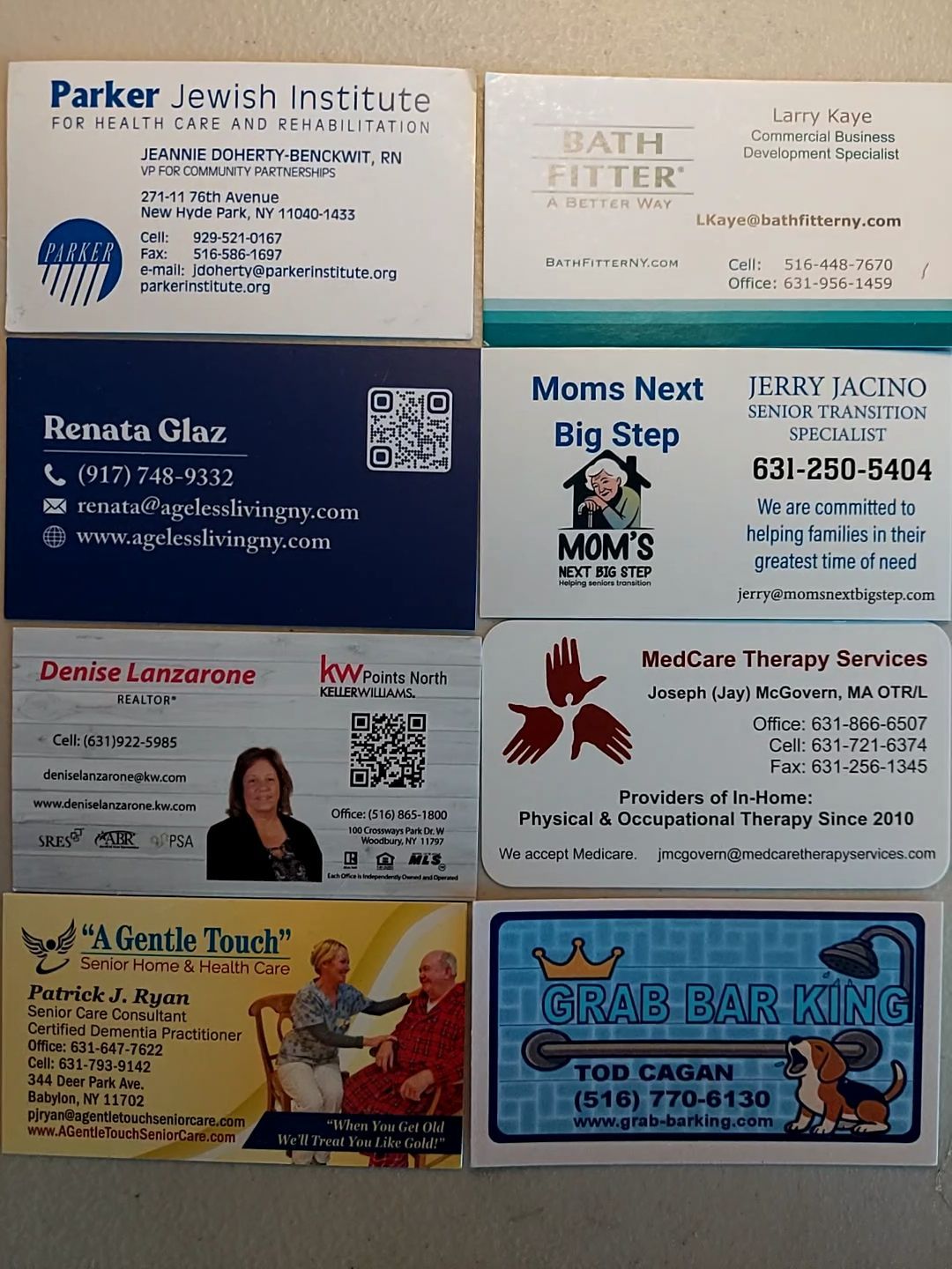 Collage of local business cards and flyers on a wall, with varied colors and contact details.