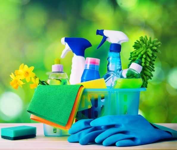A Basket Filled With Cleaning Supplies and Gloves on a Table — Doobies Cleaning Service in Port Macquarie, NSW