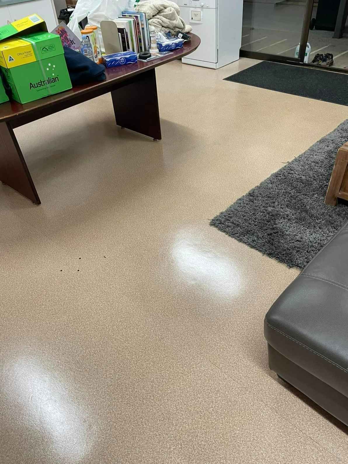 A Living Room With a Table , Couch , Rug and Boxes on the Floor — Doobies Cleaning Service in Port Macquarie, NSW