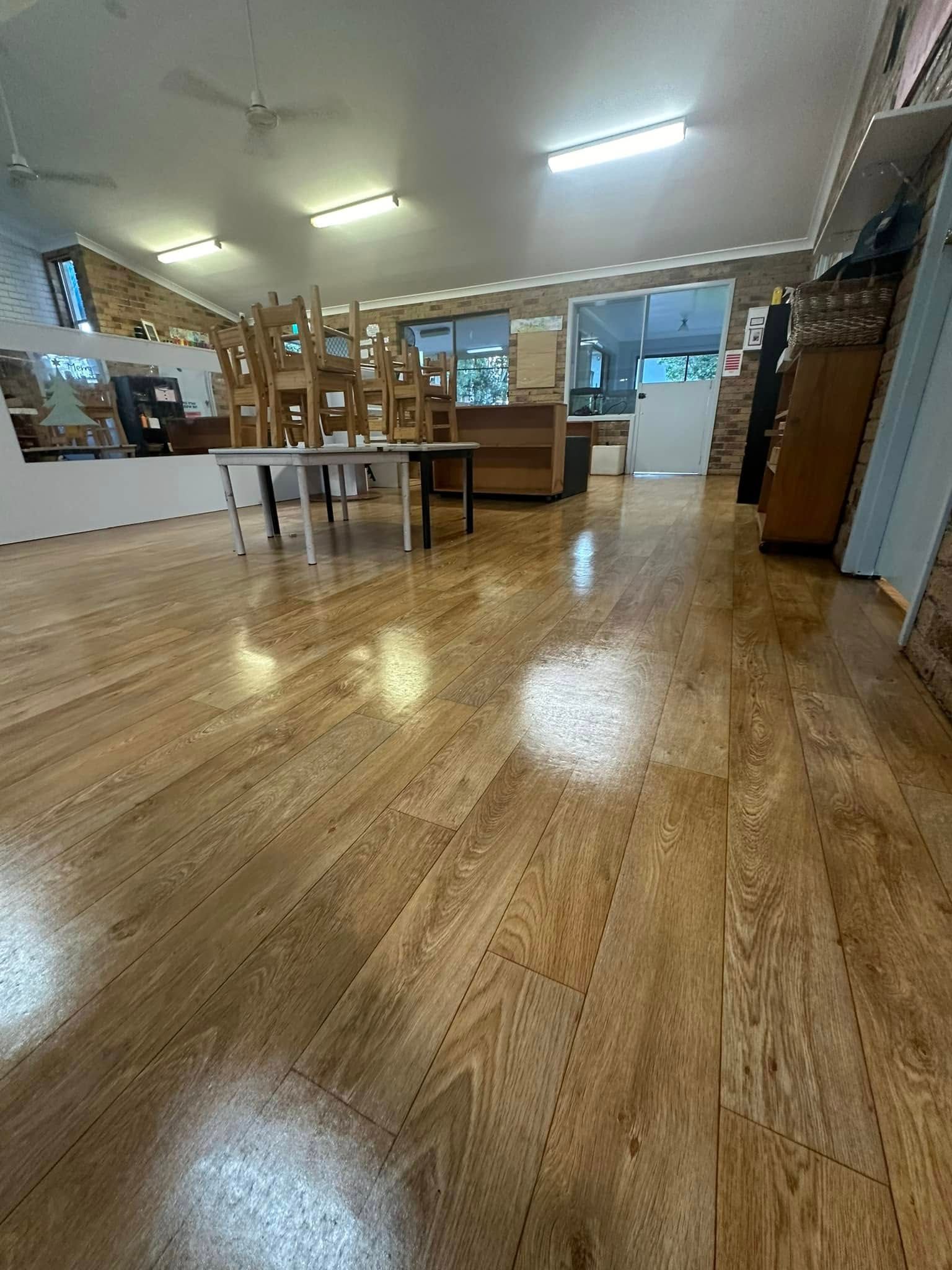 A Large Room With Wooden Floors and Tables and Chairs — Doobies Cleaning Service in Port Macquarie, NSW