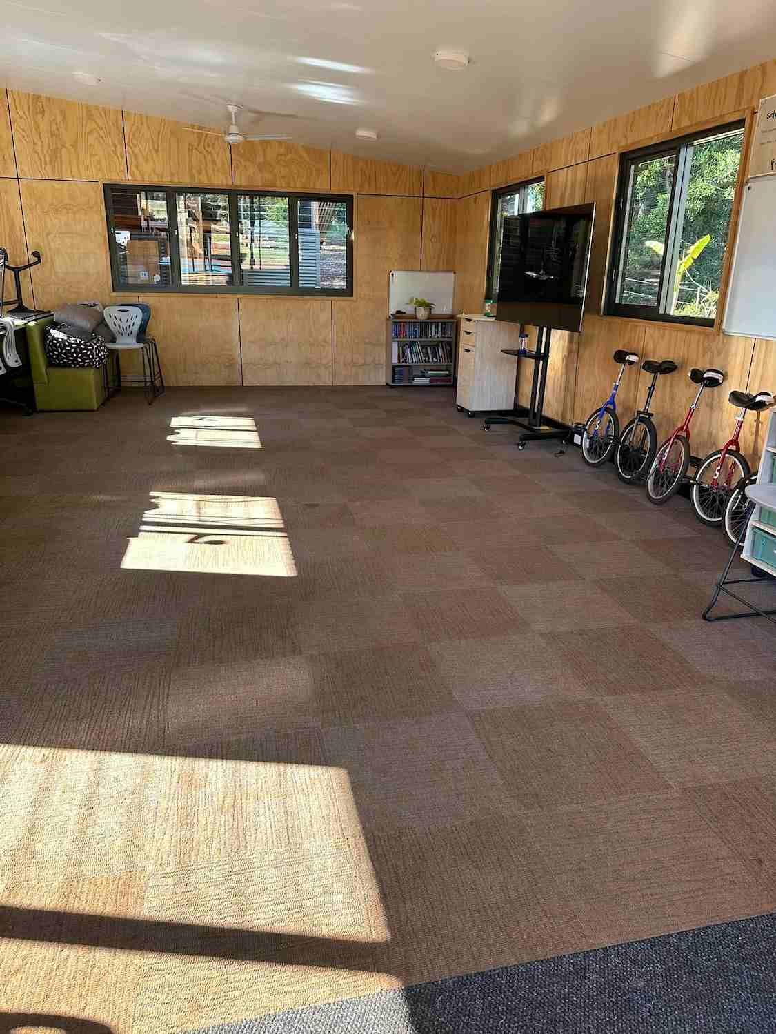 A Large Room With a Lot of Windows and Bikes on the Floor — Doobies Cleaning Service in Port Macquarie, NSW