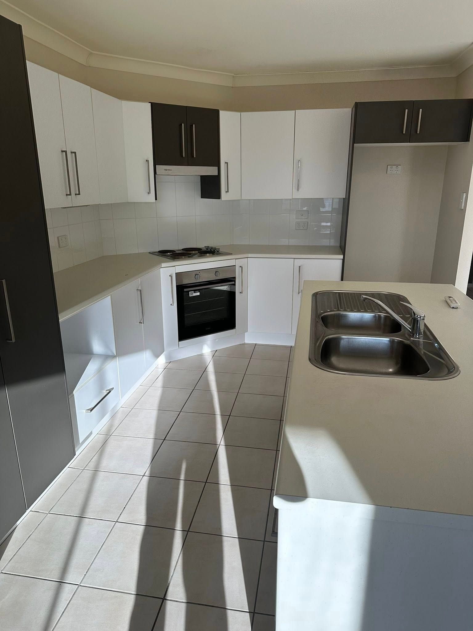 A Kitchen With White Cabinets and a Stainless Steel Sink — Doobies Cleaning Service in Port Macquarie, NSW