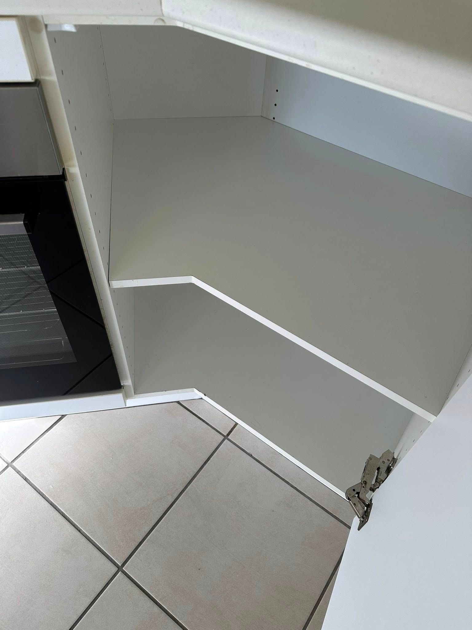 A Corner of a White Cabinet With a Tile Floor — Doobies Cleaning Service in Port Macquarie, NSW