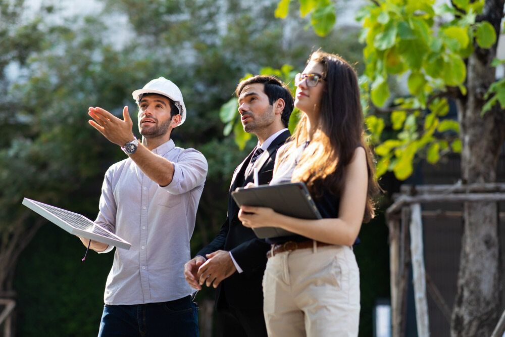 A Group Of People With Engineer Are Standing Next To Each Other — GEO – AM Consulting In Lismore, NSW