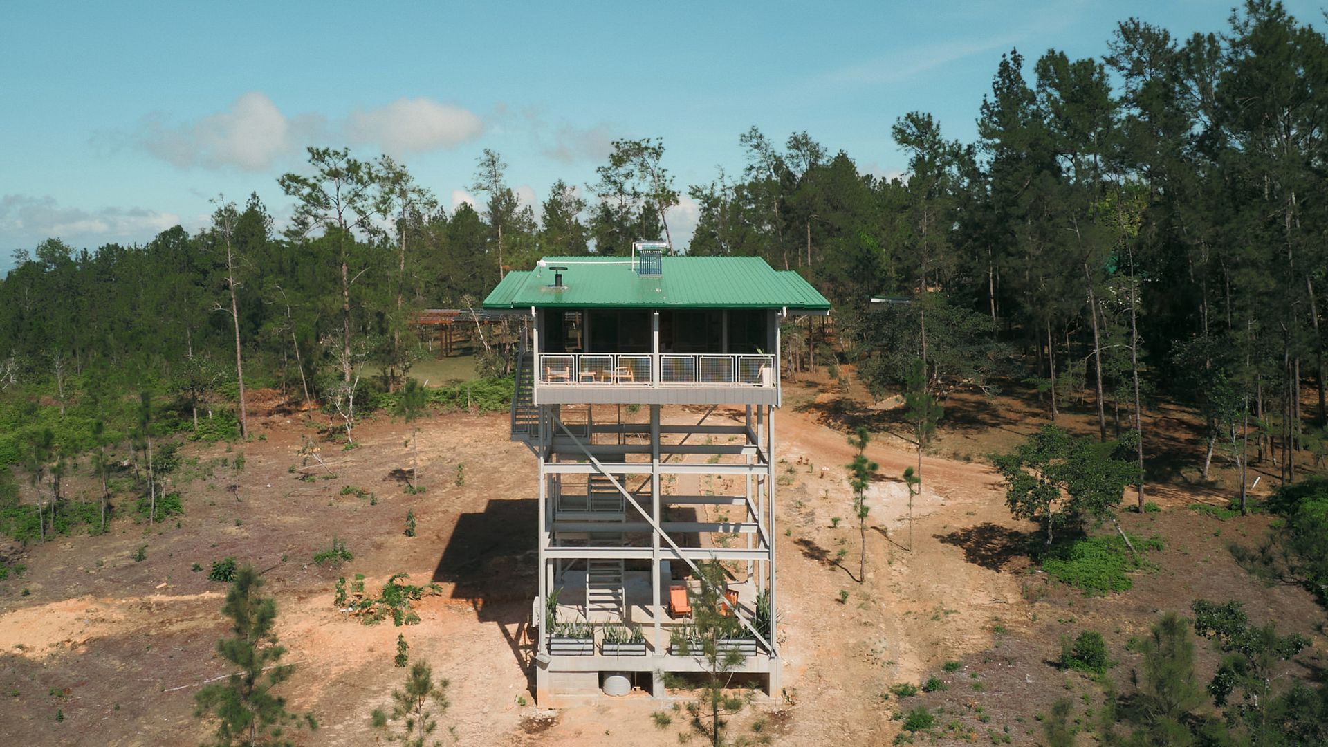 an aerial view of a house in the middle of a forest