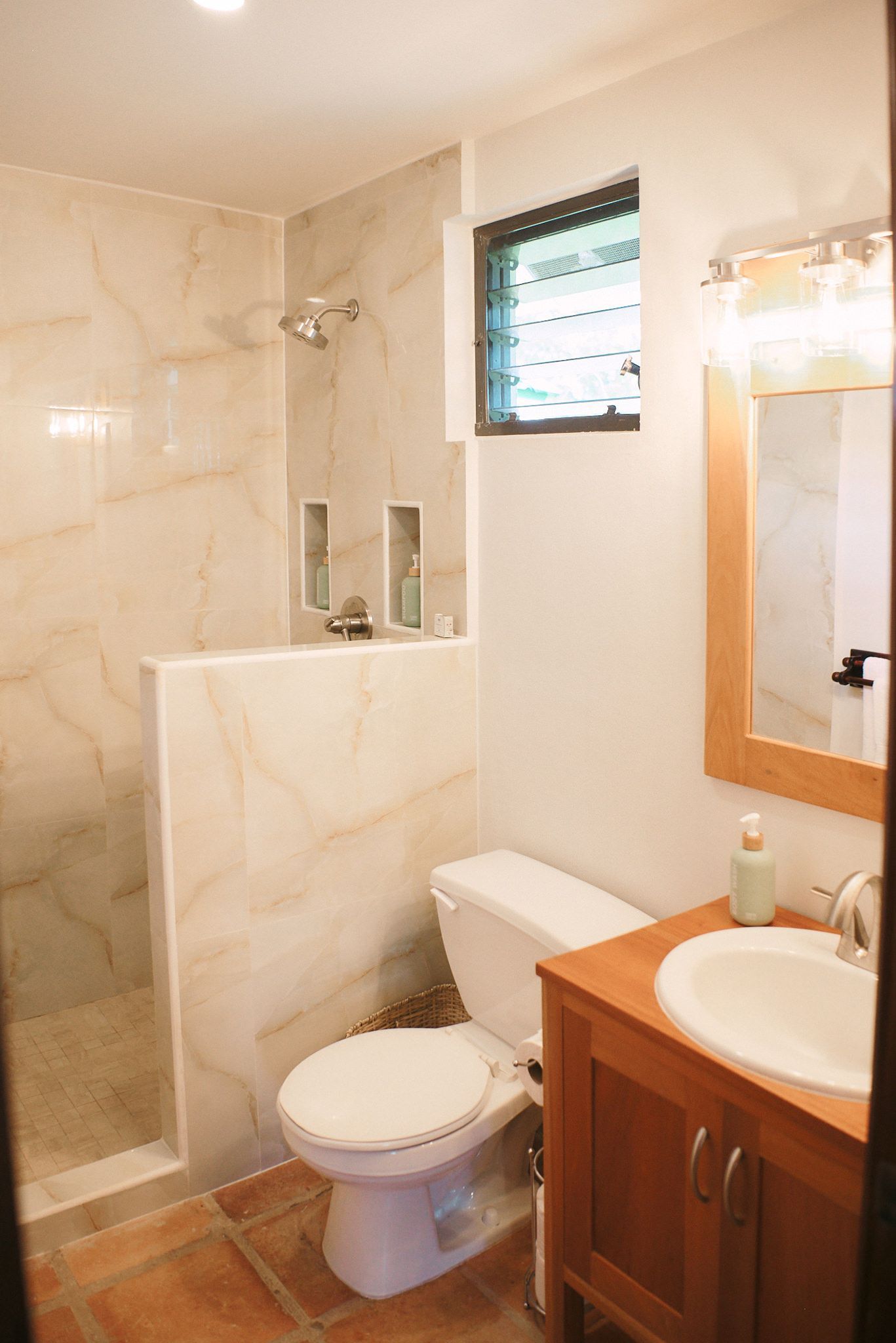 a bathroom with a toilet , sink and shower .