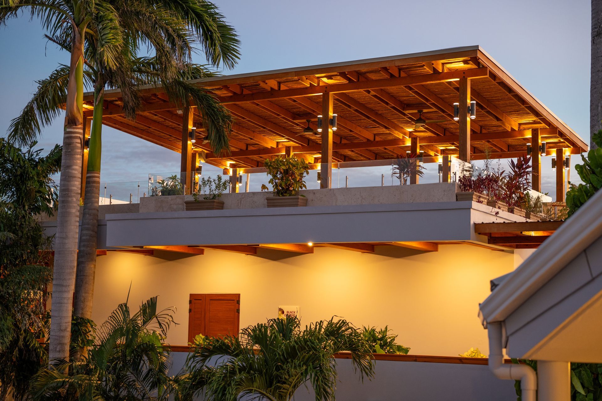 A building with a wooden roof that is lit up at night