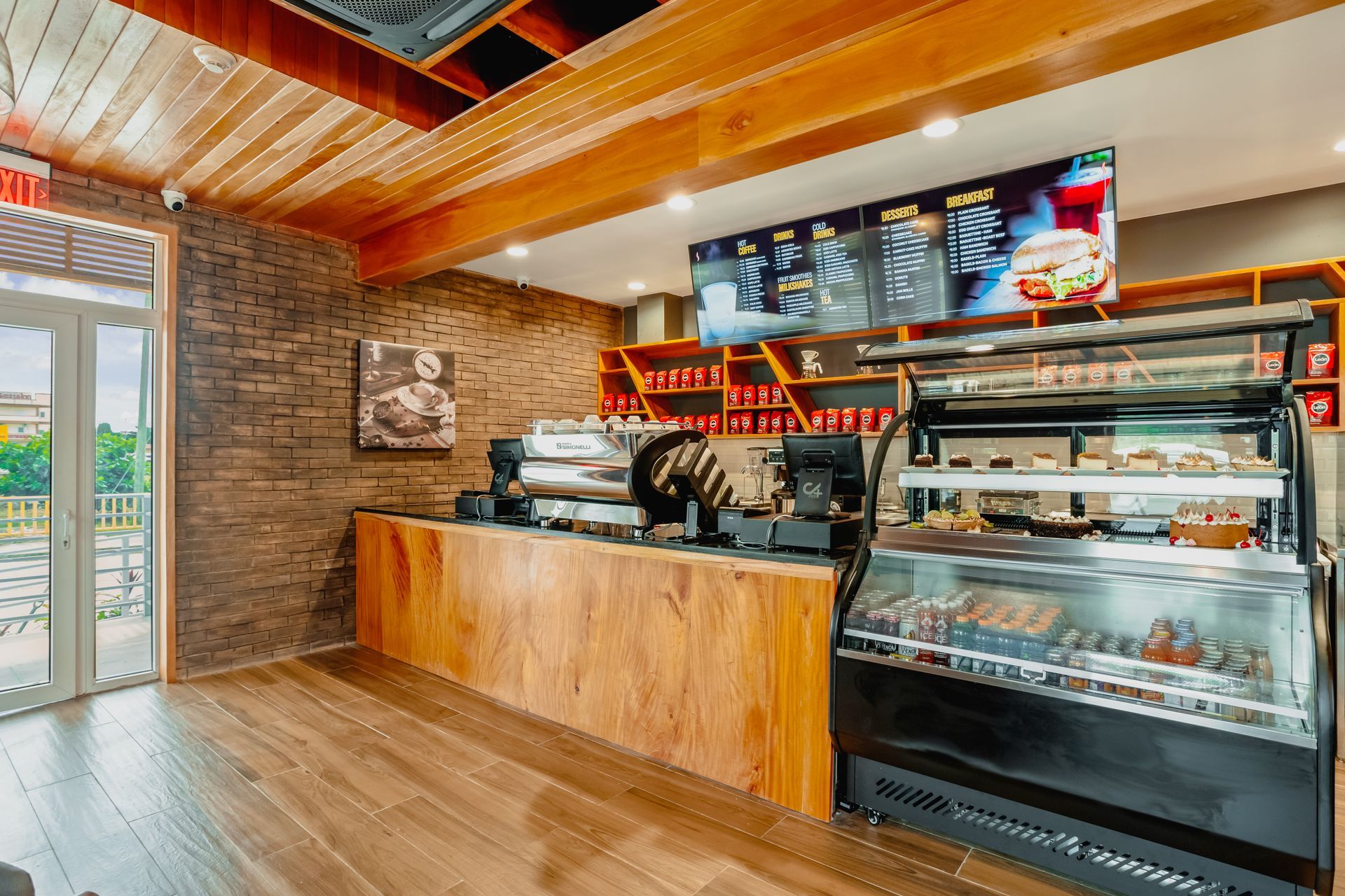 A restaurant with a wooden counter and a glass display case.
