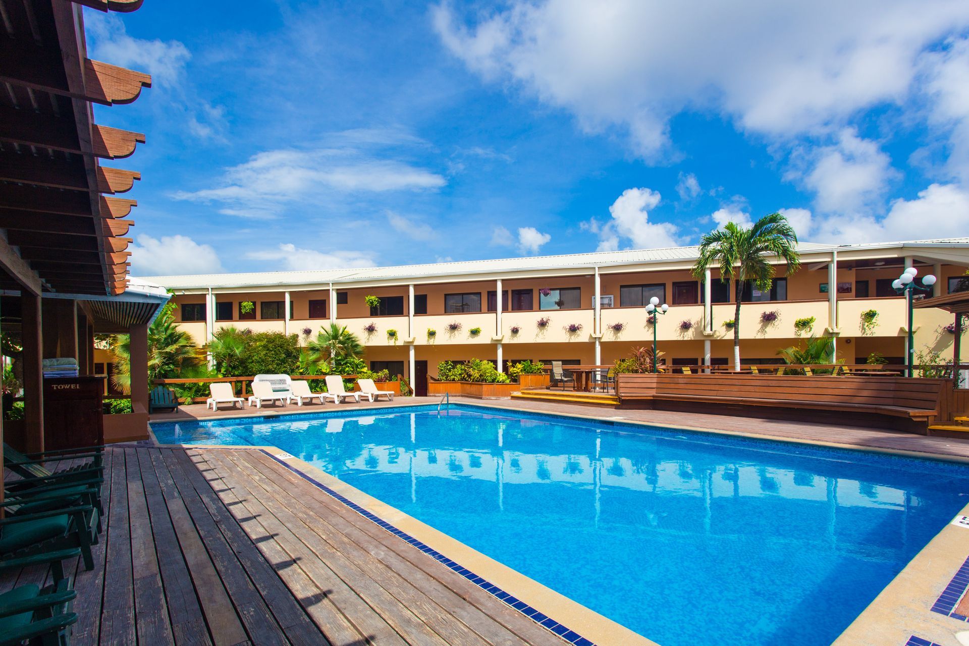 a large swimming pool in front of a hotel