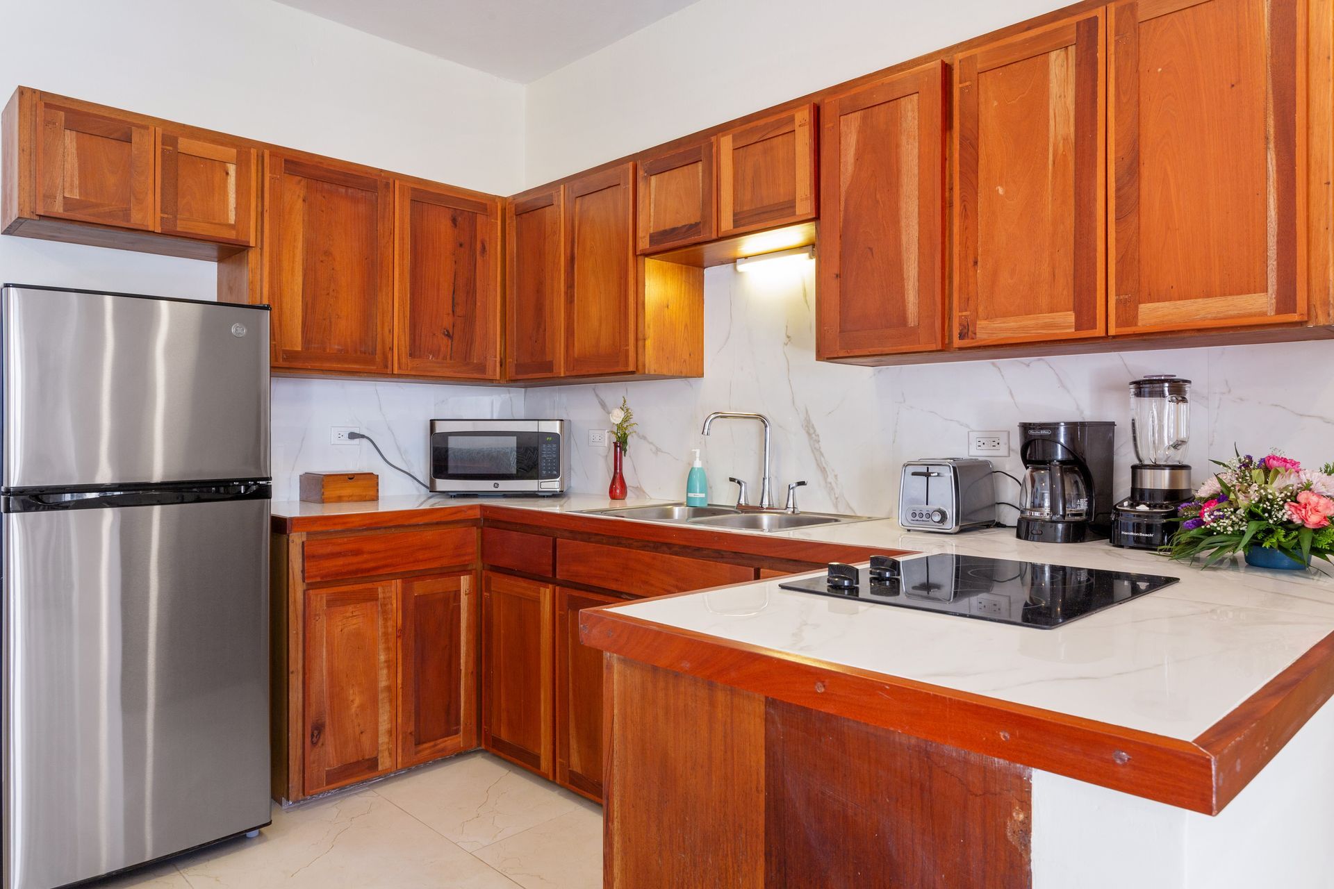 A kitchen with stainless steel appliances and wooden cabinets