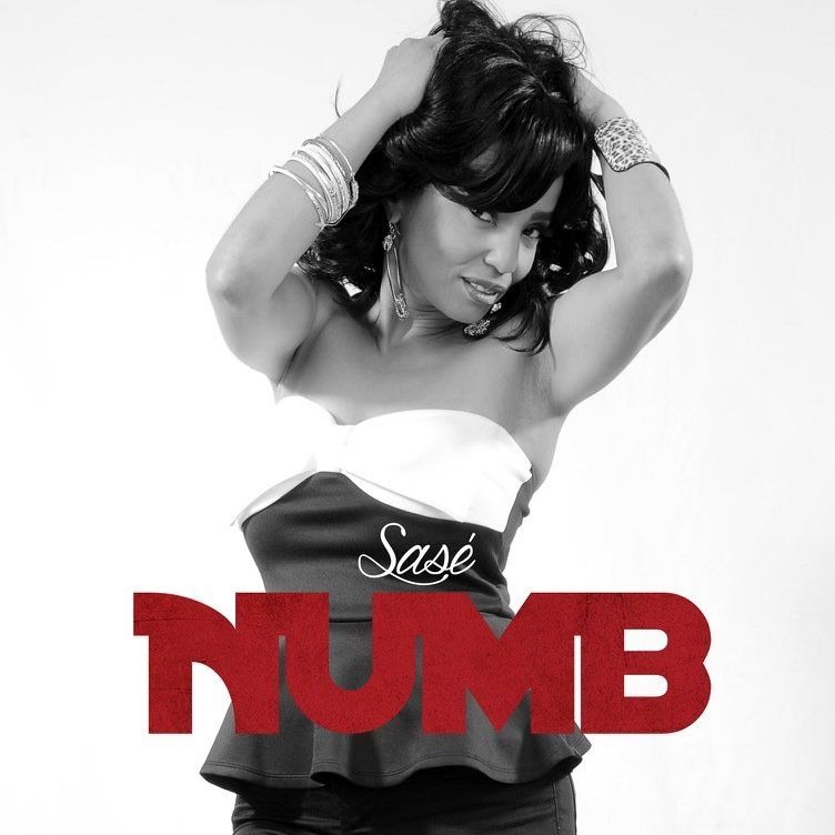 Woman in black and white dress, posing for music cover