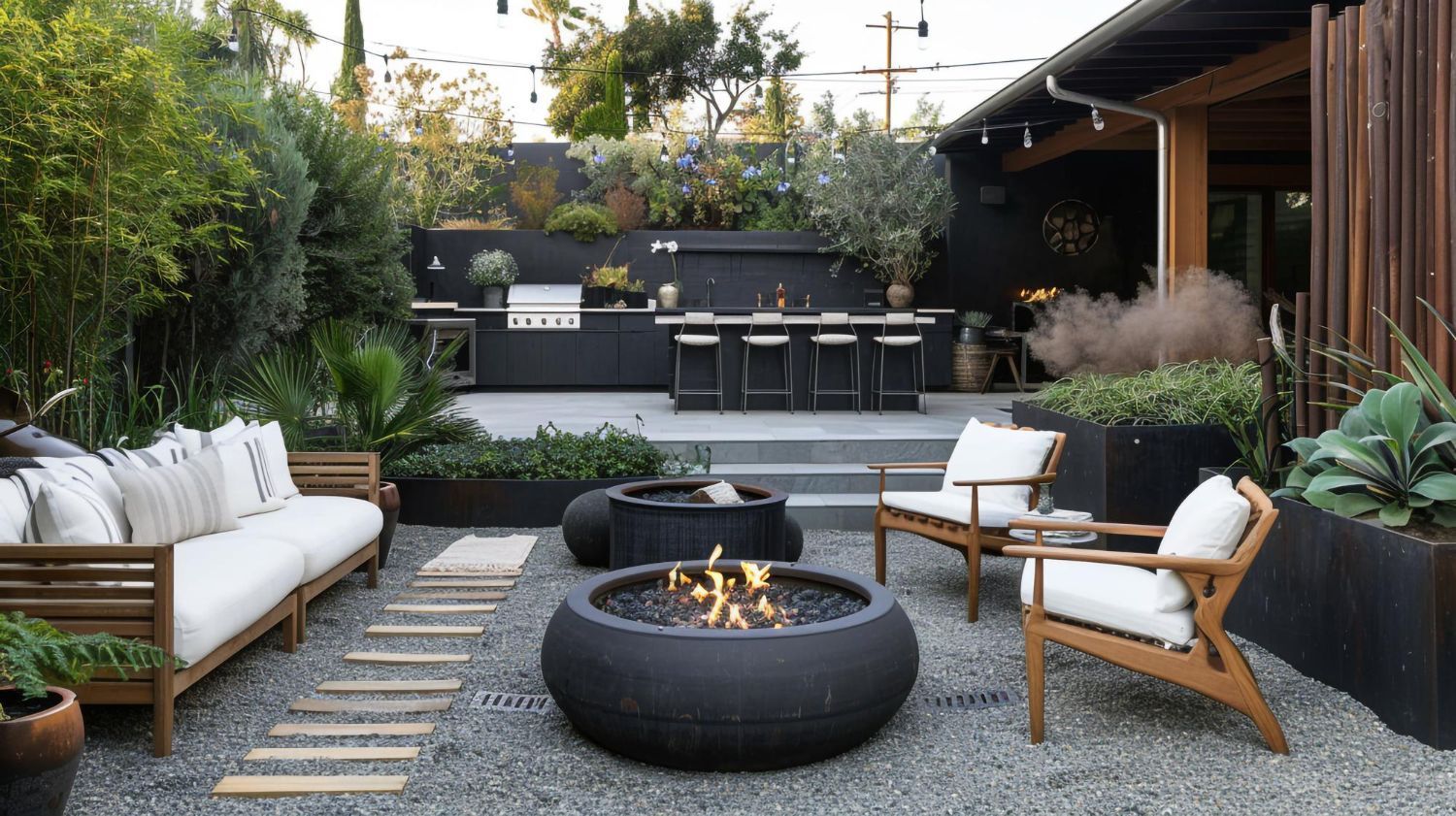 Modern backyard patio with fire pit, outdoor seating, and a built-in grill area