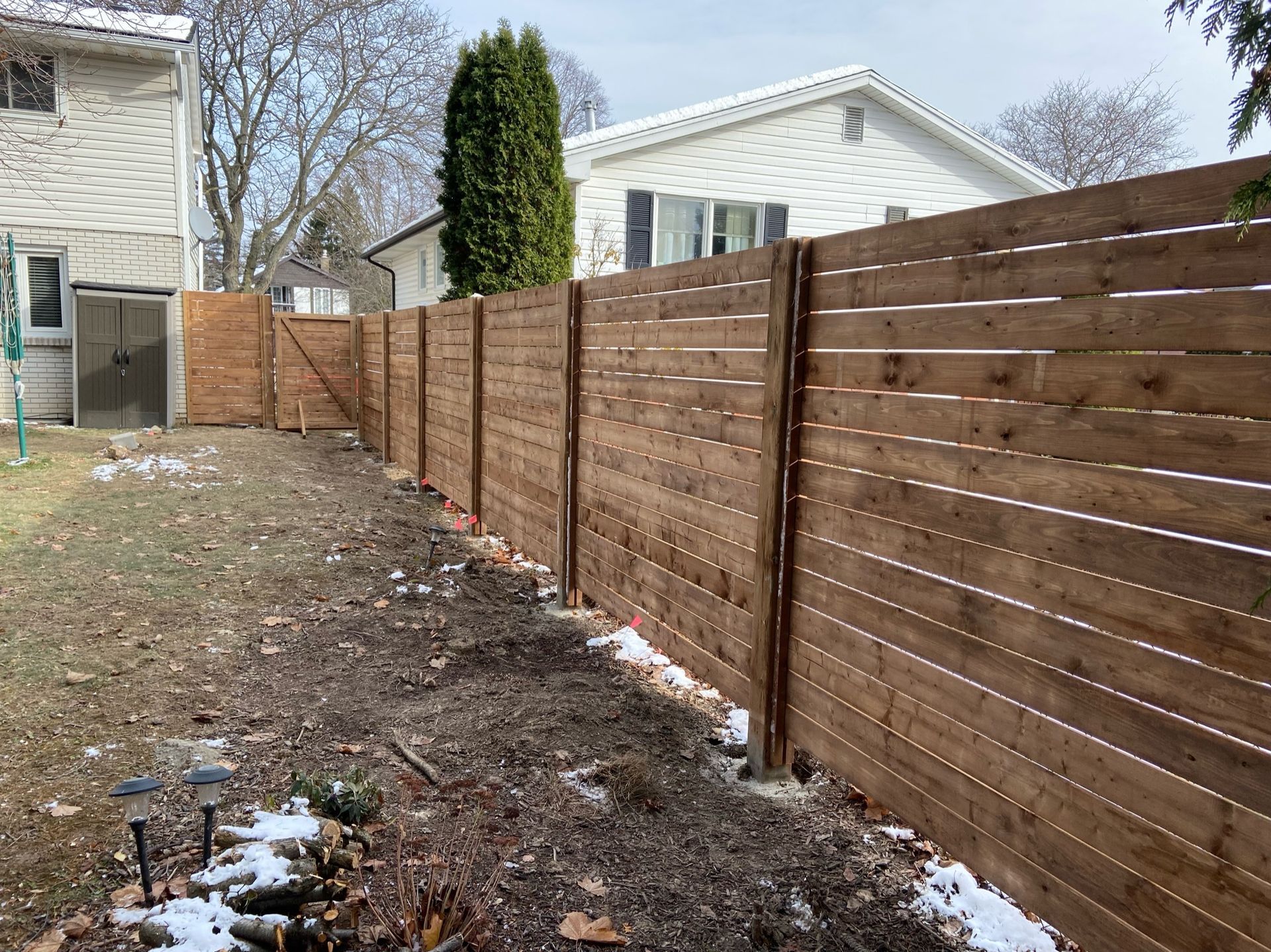 A brick fireplace is sitting on a brick patio next to a tree.