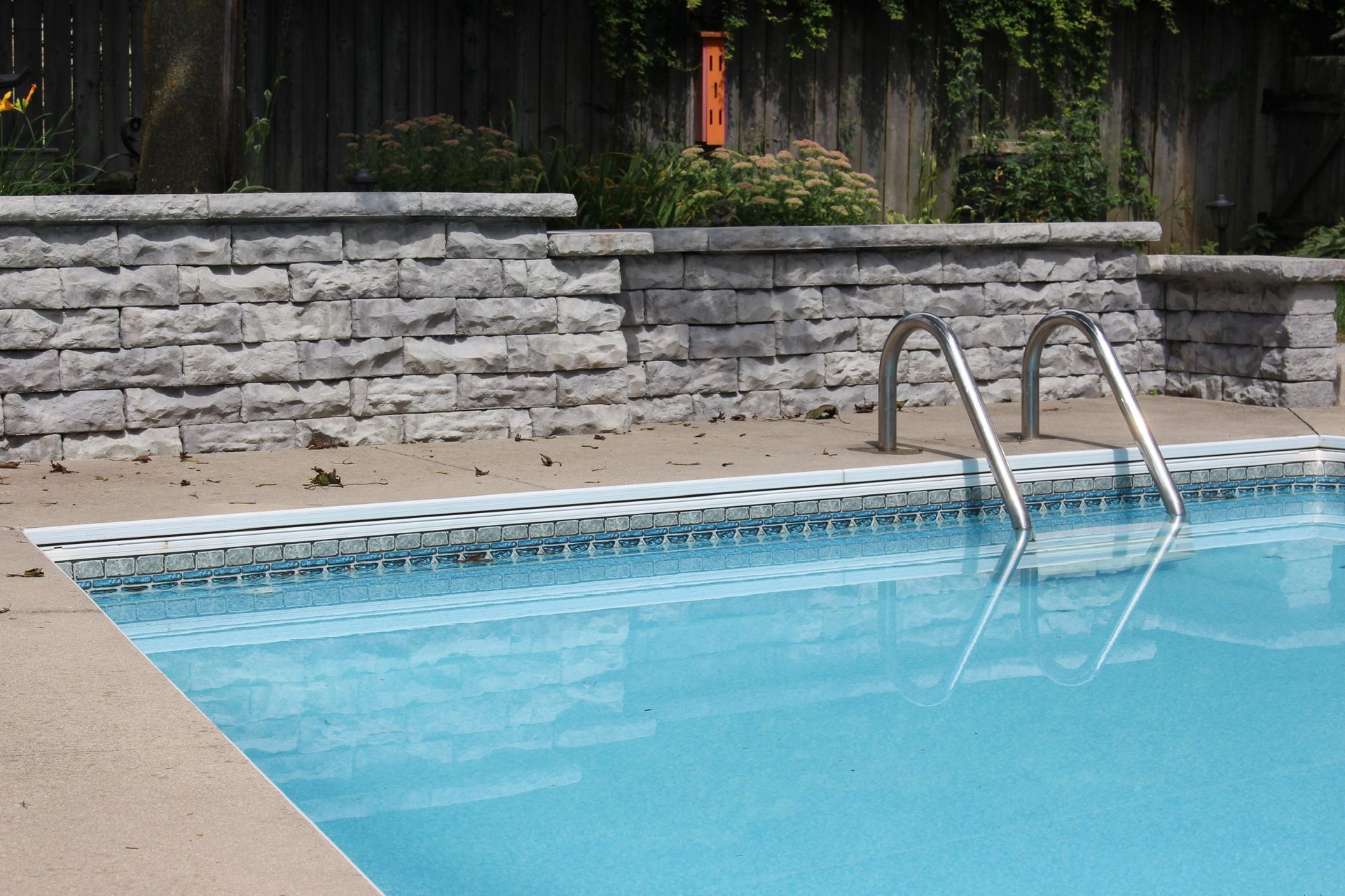 A swimming pool with a ladder leading to it