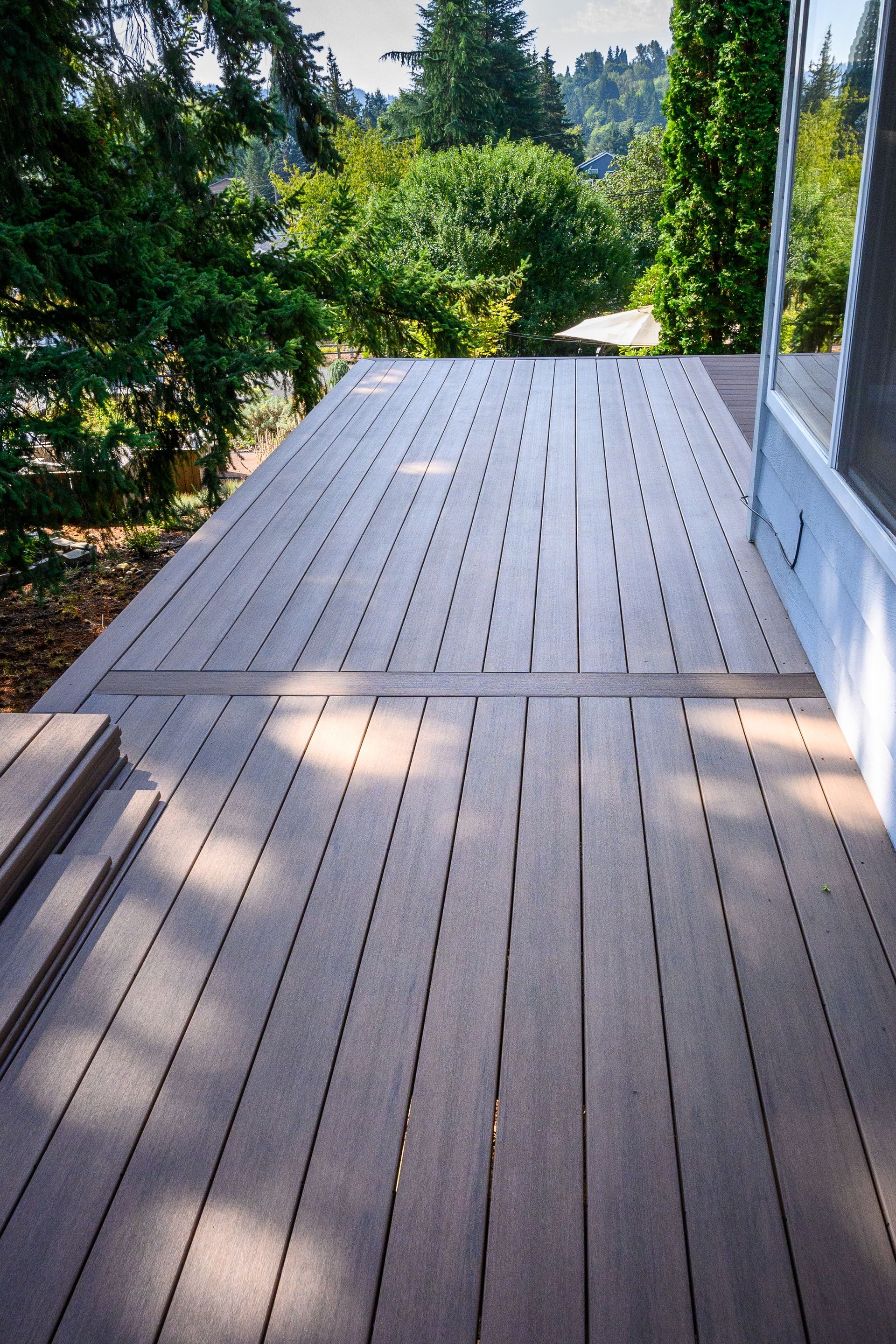 A wooden deck with trees in the background
