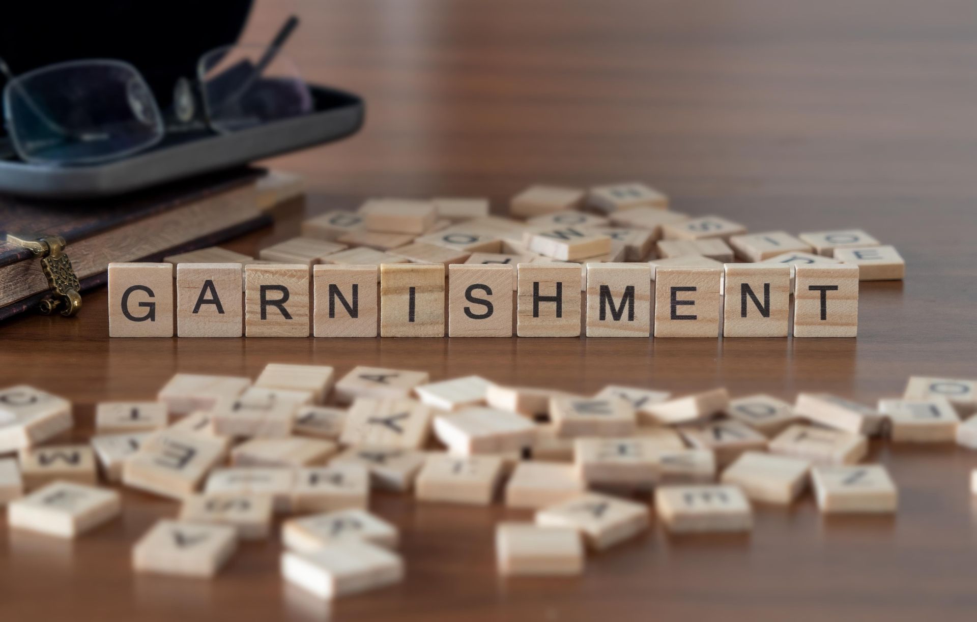 Non-Bankruptcy Alternatives — Court Documents in Valdosta, GA Wooden letter tiles spelling “garnishment” on desk with scattered pieces.